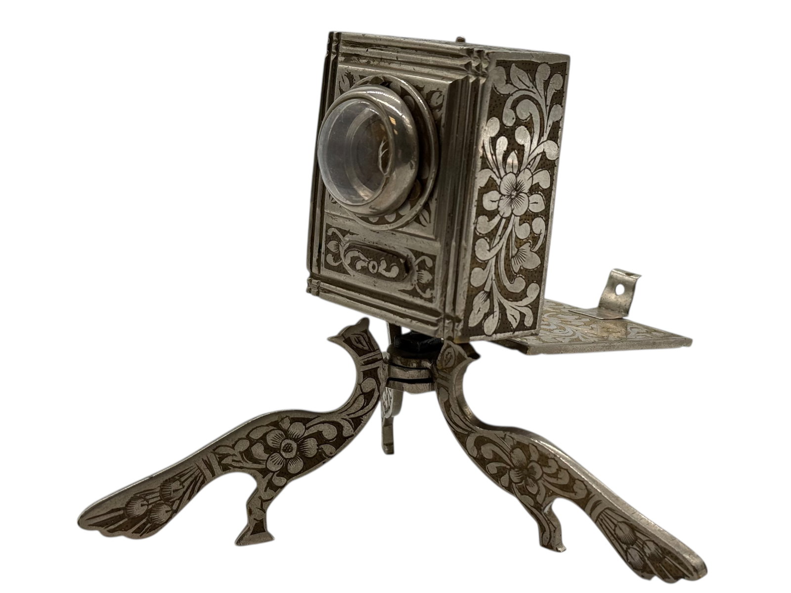 A Continental silvered metal musical box, early 20: A Continental silvered metal musical box, early 20A Continental silvered metal musical box, early 20th century. The movement appears to function and plays music when wound. H: 5 inches W: 2 3/8