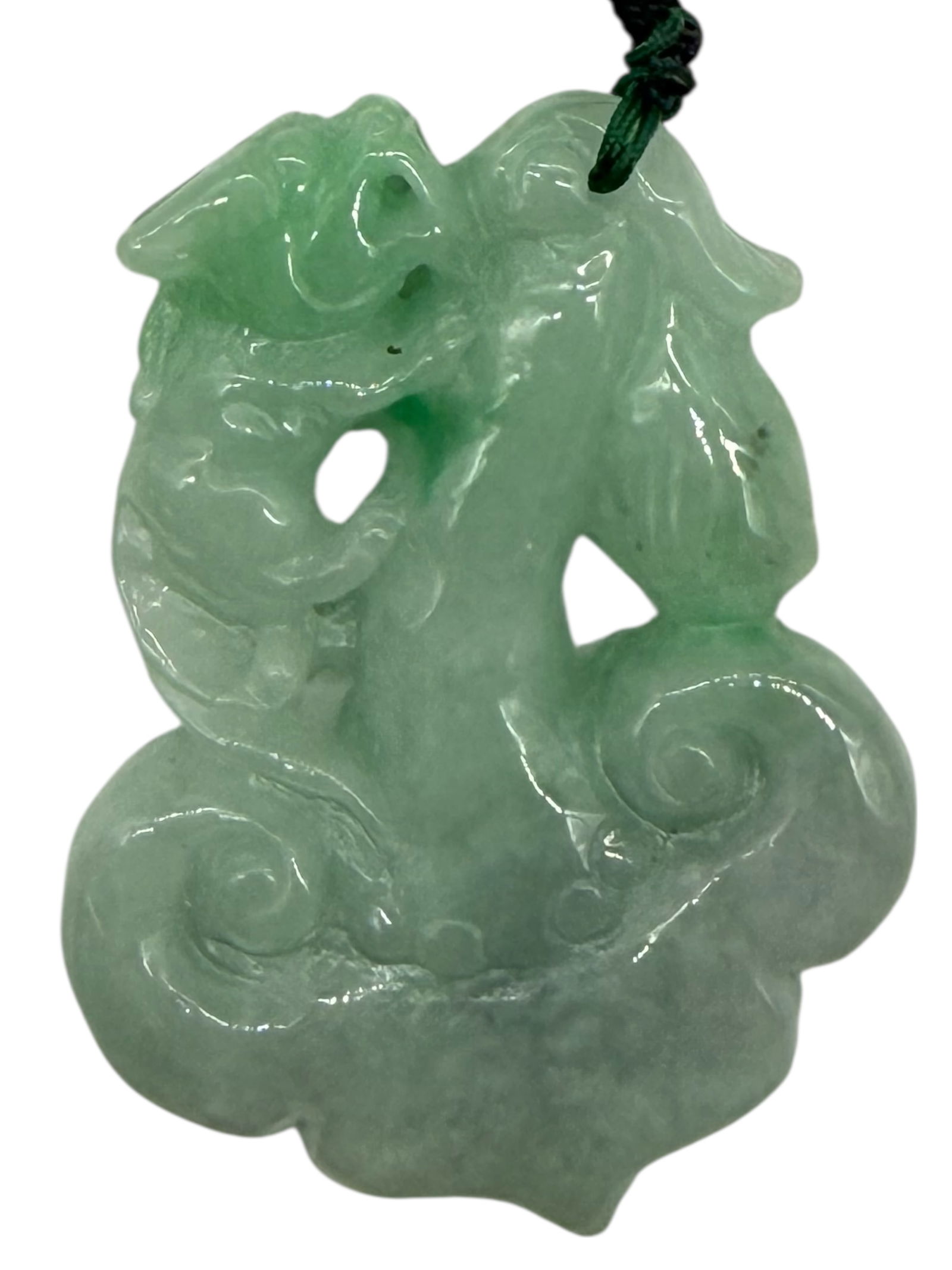 A Carved Green Stone Mythical Beast Pendant: A Carved Green Stone Mythical Beast PendantH: 2 1/2 inches W: 2 inches