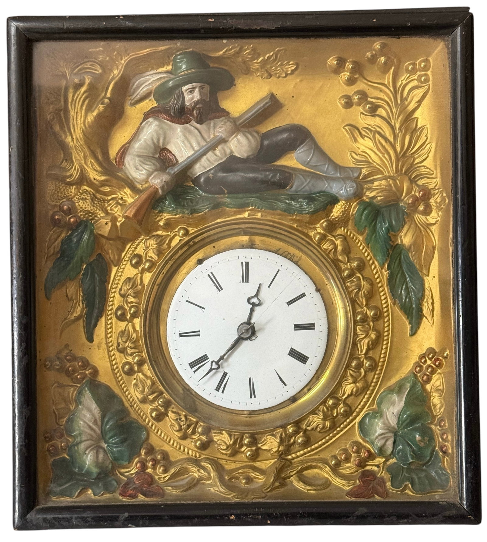 German Black Forest "picture frame" wall clock: With a gilt metal dial surround, relief decoration, and hunter figure surmount. H: 13 inches W: 12 inches D: 5 1/2 inches