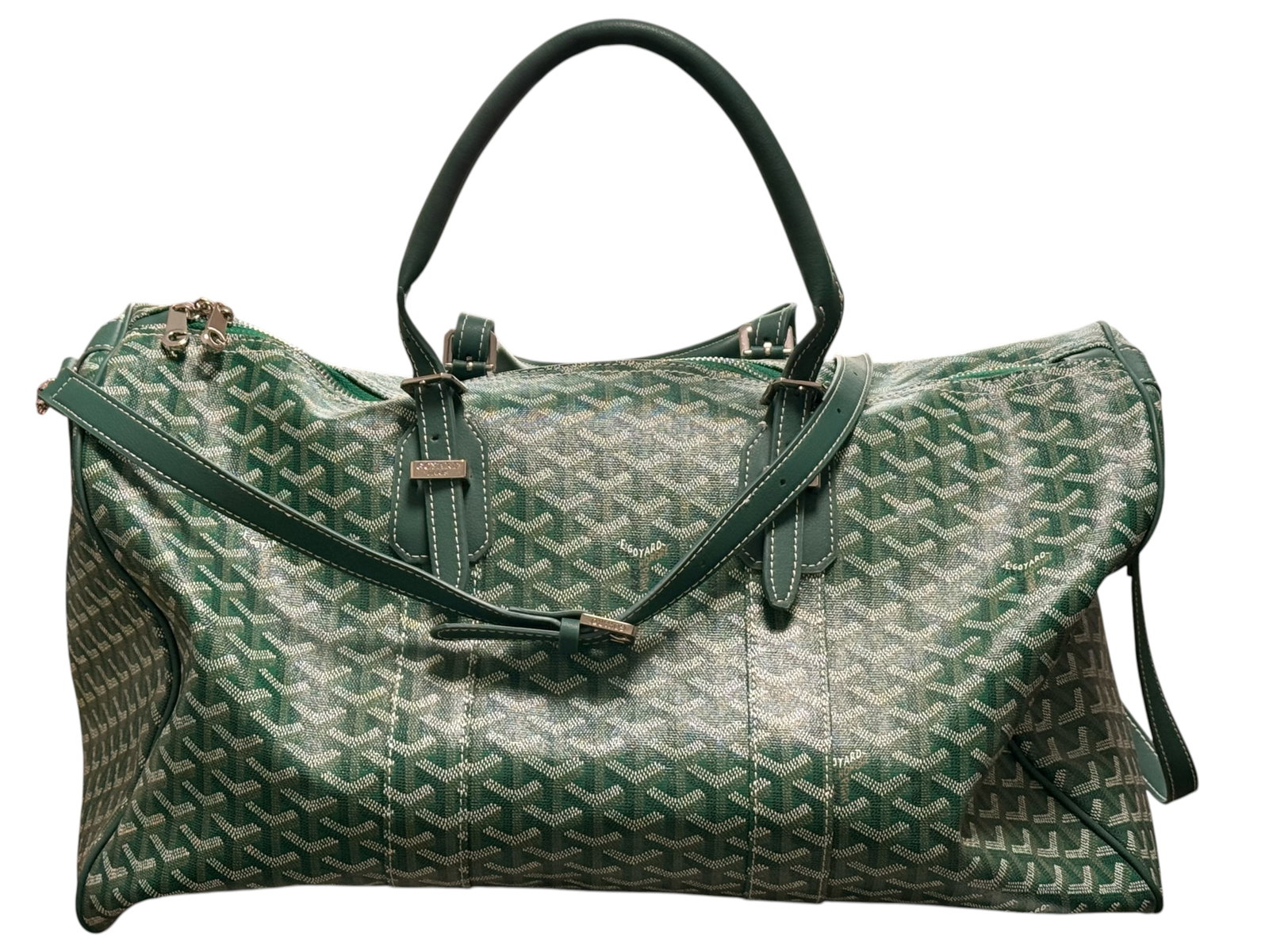 A Goyard Green Coated Canvas Duffle Bag: With monogram-patterned coated canvas, leather handles, shoulder strap, and metal hardware. L: 20 inches W: 10 1/2 inches D: 10 1 /2 inches