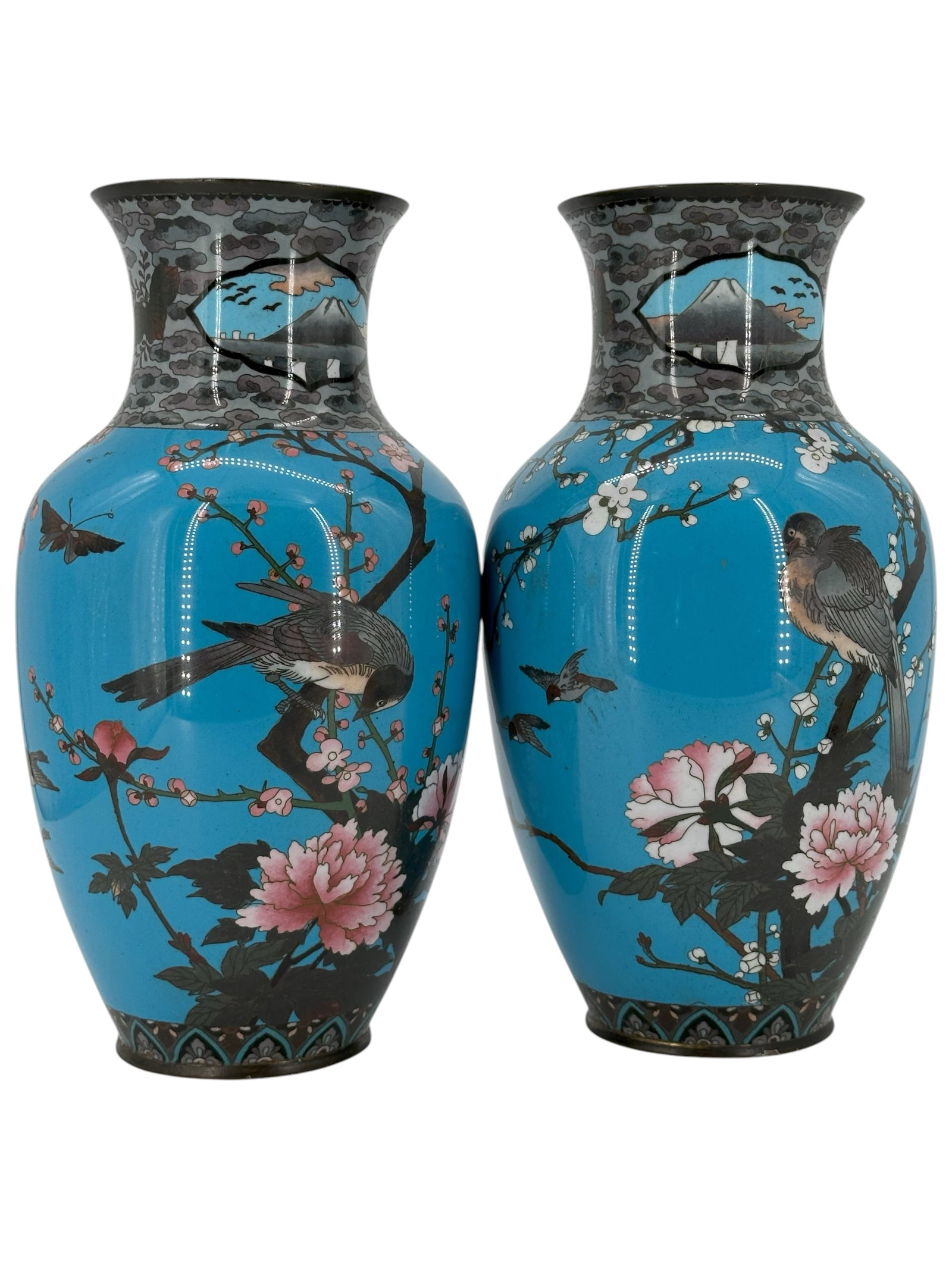 A Pair of Chinese Cloisonné Enamel Vases: Each decorated with birds, flowering branches, and Mount Fuji against a turquoise ground. 12" H X 5 1/2" each