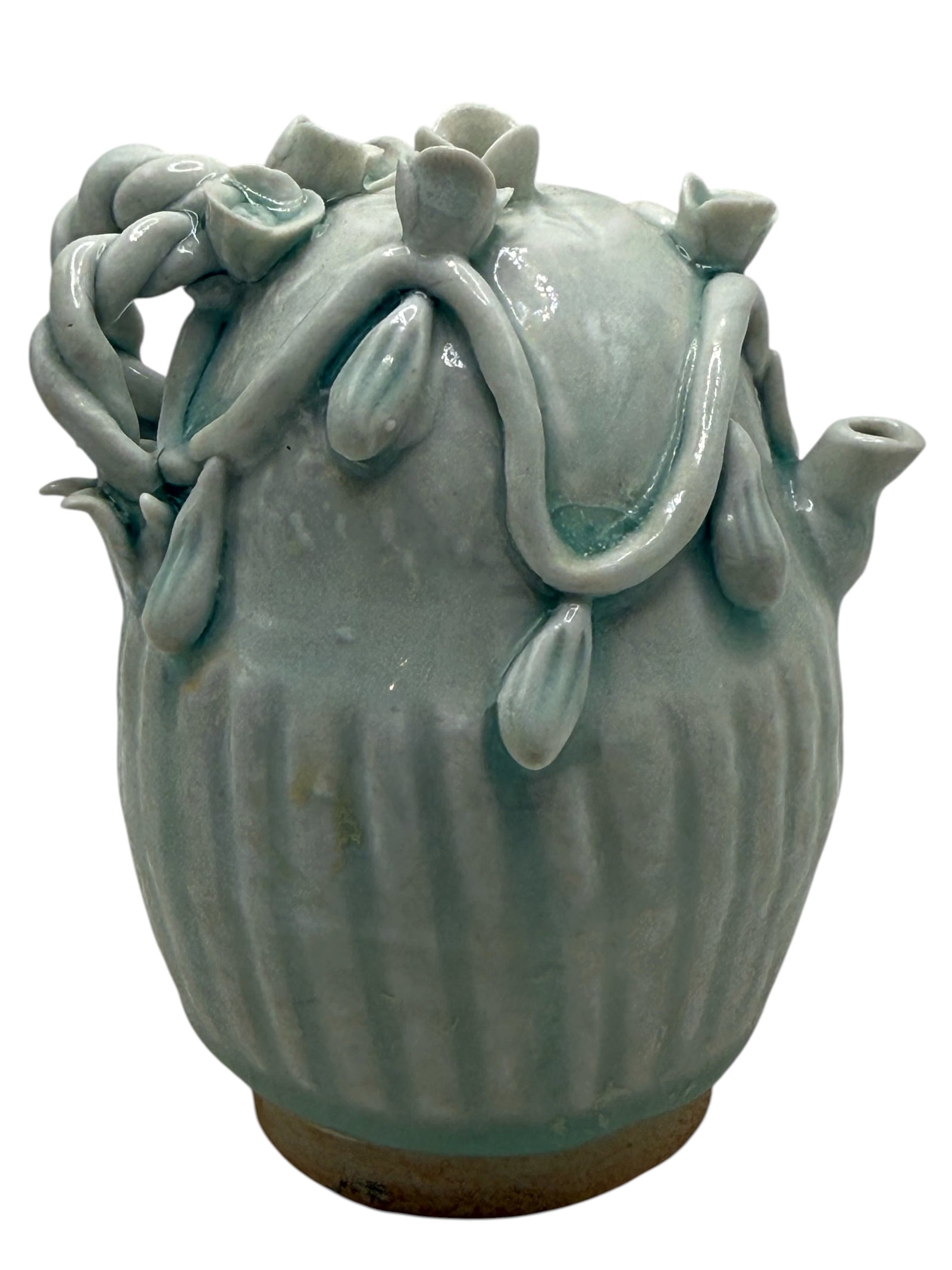 A Chinese Celadon Glazed Porcelain Ewer: Molded with vertical lobes, applied with vine and gourd decoration beneath a pale celadon glaze. H: 3 3/4 inches W: 2 3/4 inches