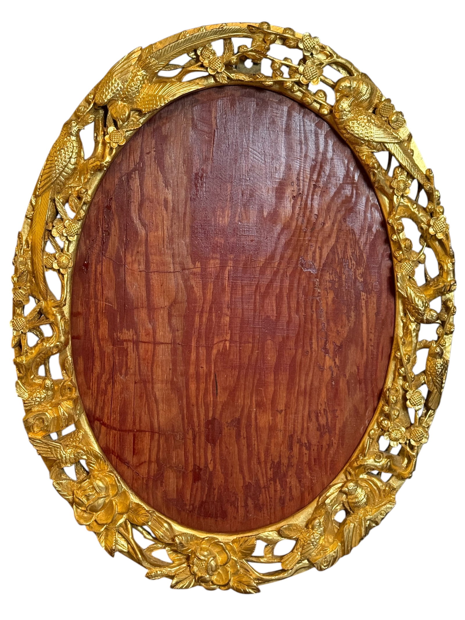 A Chinese Giltwood Oval Frame: The openwork frame carved with birds, flowering branches, and foliage, enclosing an oval wood panel. H: 23 inches W: 18 inches