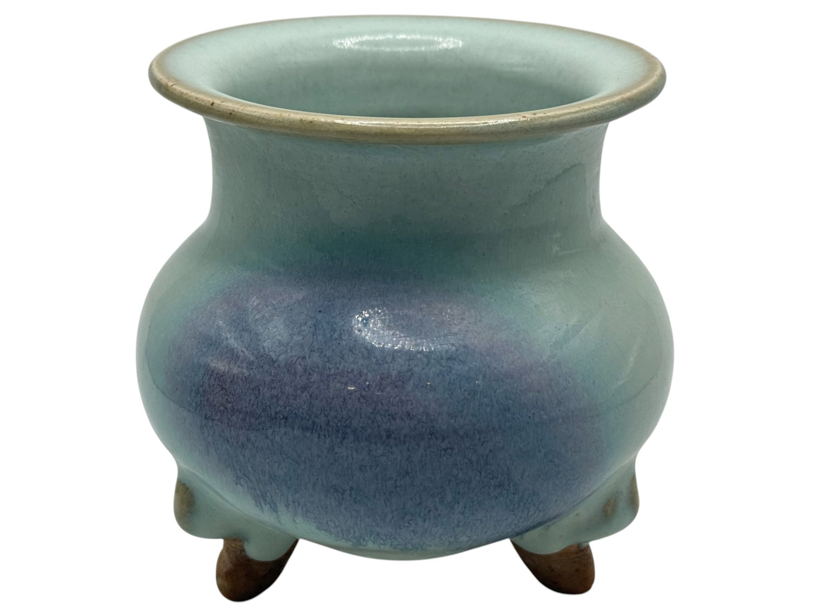 A Chinese Jun-Style Tripod Censer: Of compressed globular form, covered in a lavender-blue flambé glaze, raised on three feet. H: 4 1/2 inches W: 4 1/4 inches