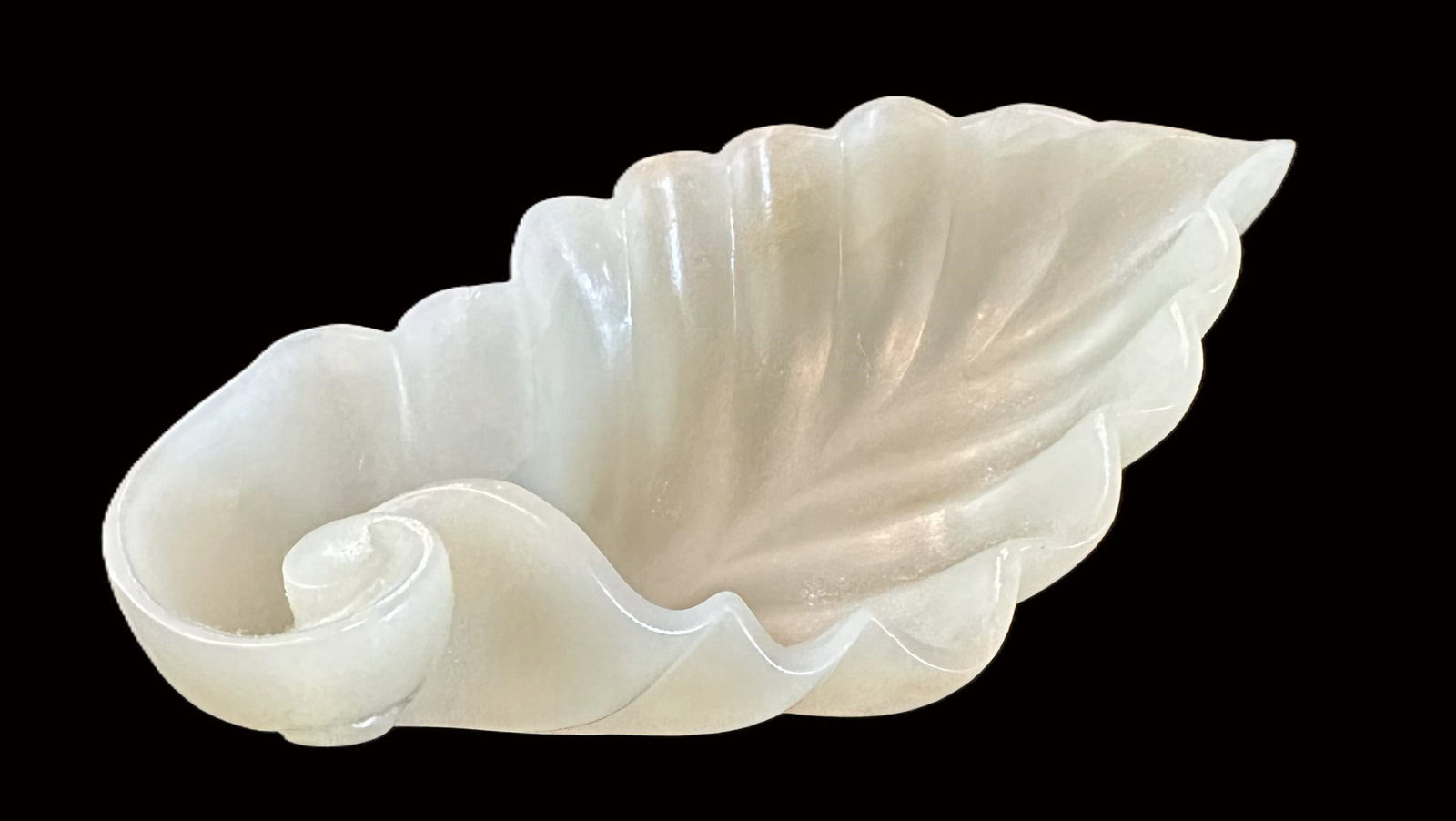 A Chinese White Jade Brush Washer: Carved in the form of a curled lotus leaf with deeply lobed rim and scrolling stem. #2219 Size: 1 3/8"*4 1/2"*2 1/8"