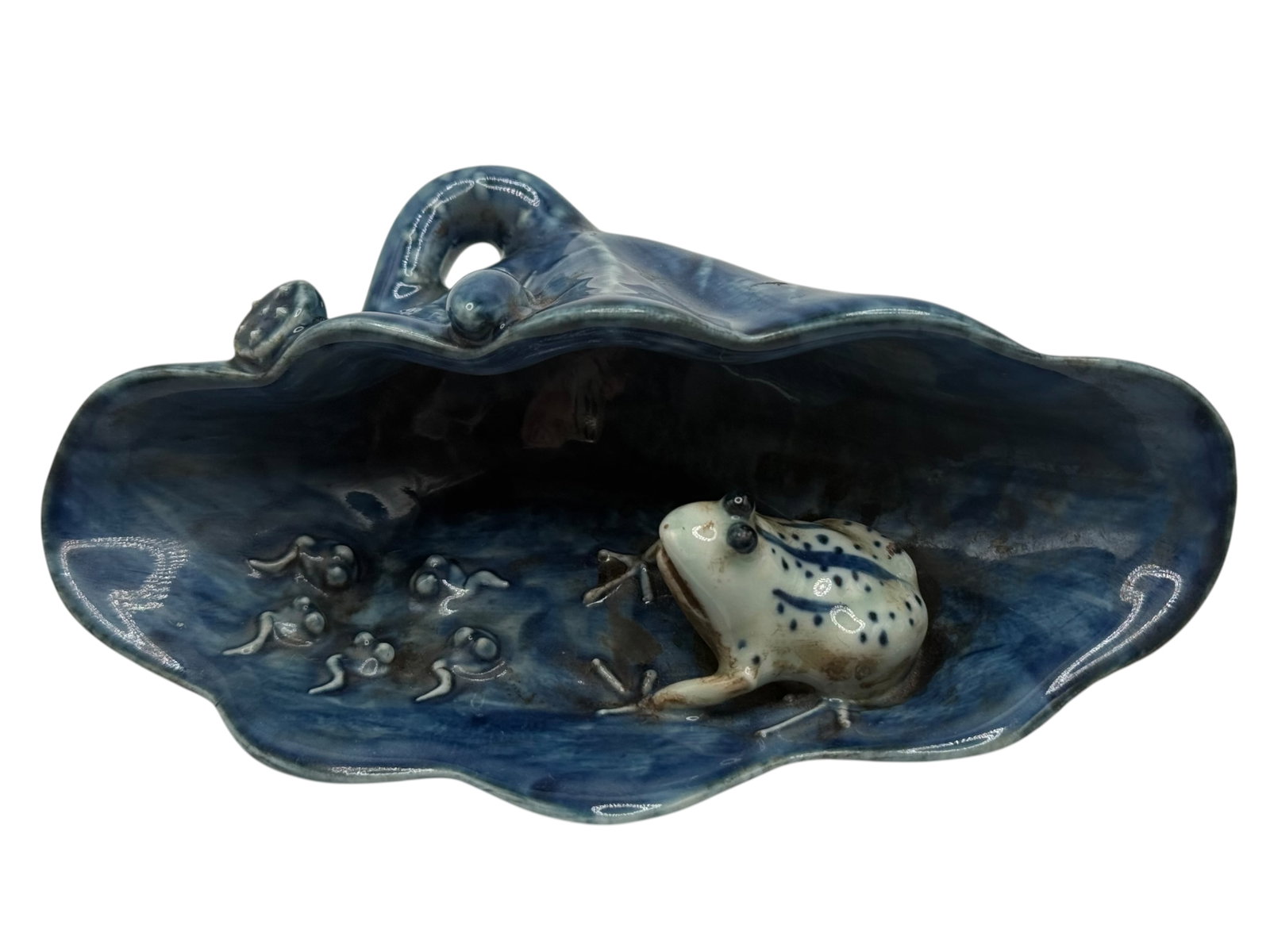 A Chinese Glazed Pottery Brush Washer: Modeled as a lotus leaf with a frog in the interior, covered in a mottled blue glaze, the underside bearing an apocryphal mark. H: 2 1/2 inches W: 6 inches