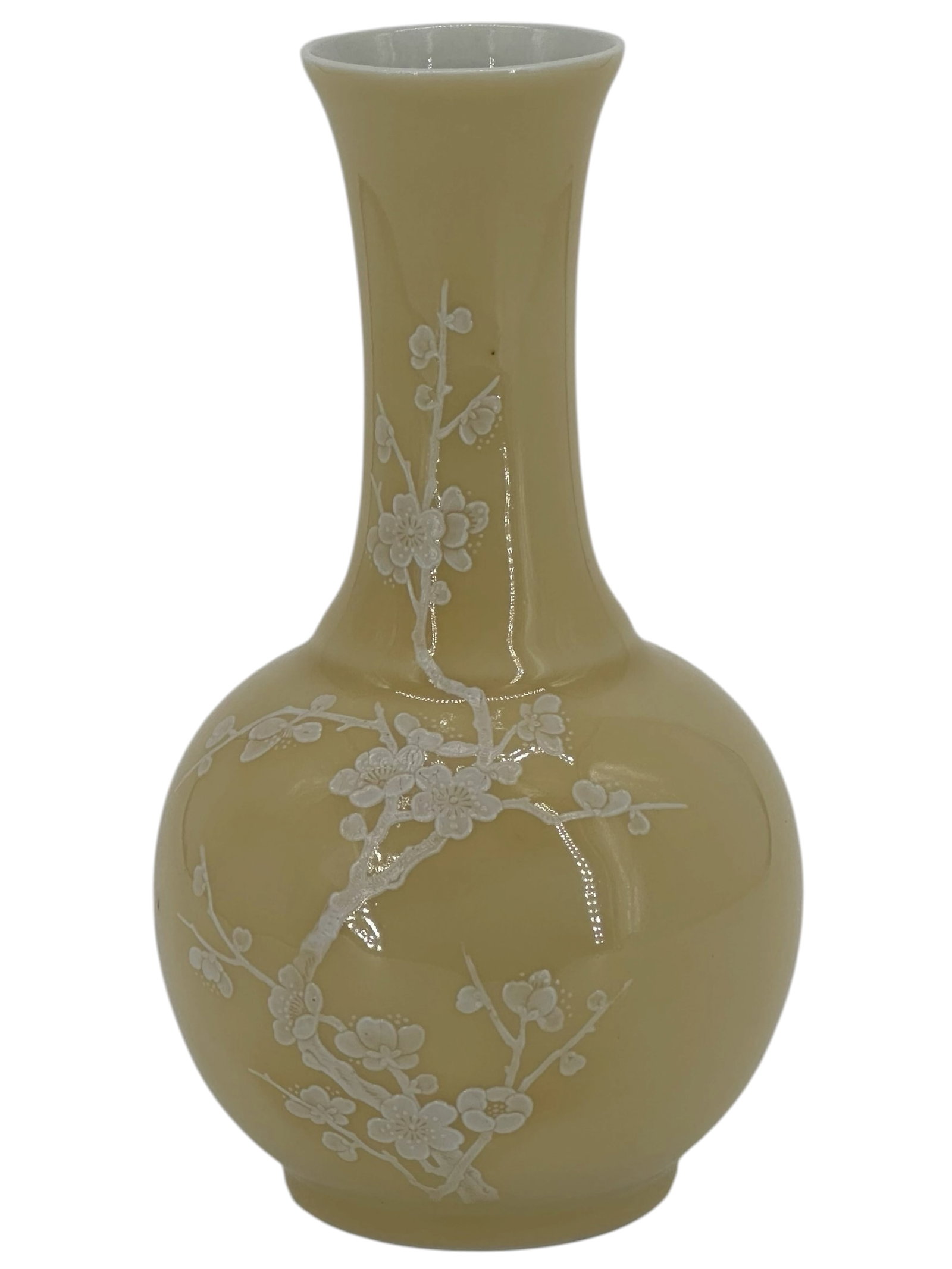 A Chinese Yellow Monochrome Vase: Of pear-shaped form with a flared neck, decorated with molded prunus branches reserved in white against a beige glaze. 7 1/2" * 4"