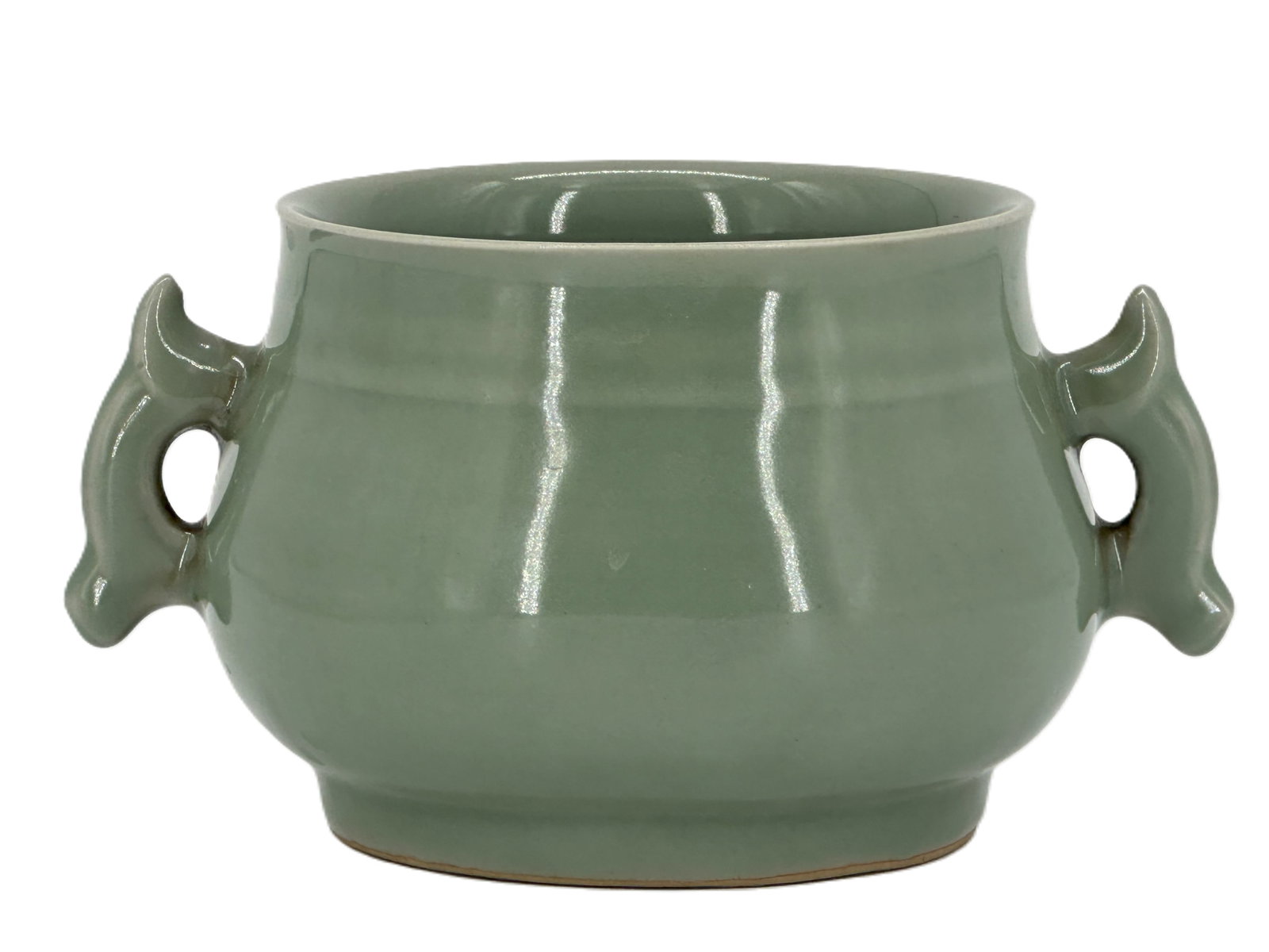 A Chinese Celadon-Glazed Censer: Of compressed circular form with twin loop handles, covered in a celadon glaze. Size: 4 1/4" * 7 1/2"