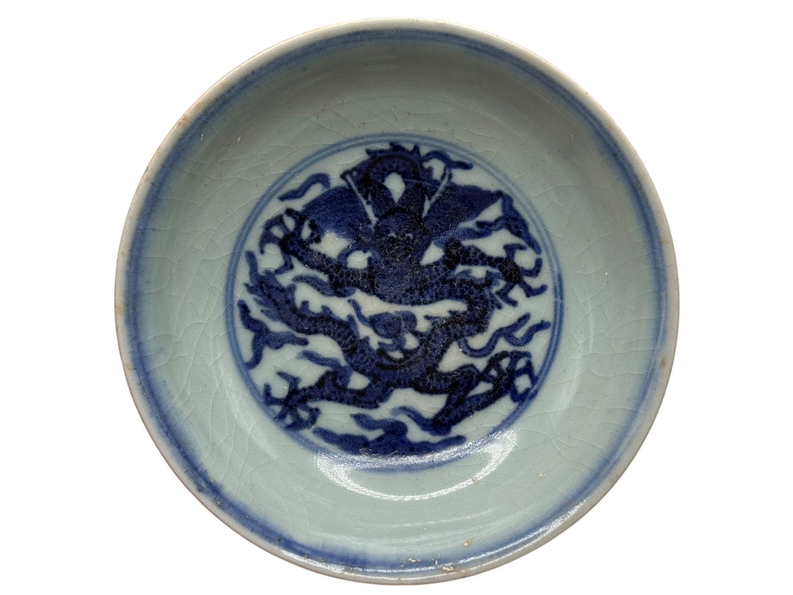 A Chinese Blue and White Porcelain Dish: Decorated to the interior with a dragon medallion, the exterior with cranes and floral sprays, the base bearing an apocryphal six-character mark. H: 1 1/2 inches W: 5 1/2 inches