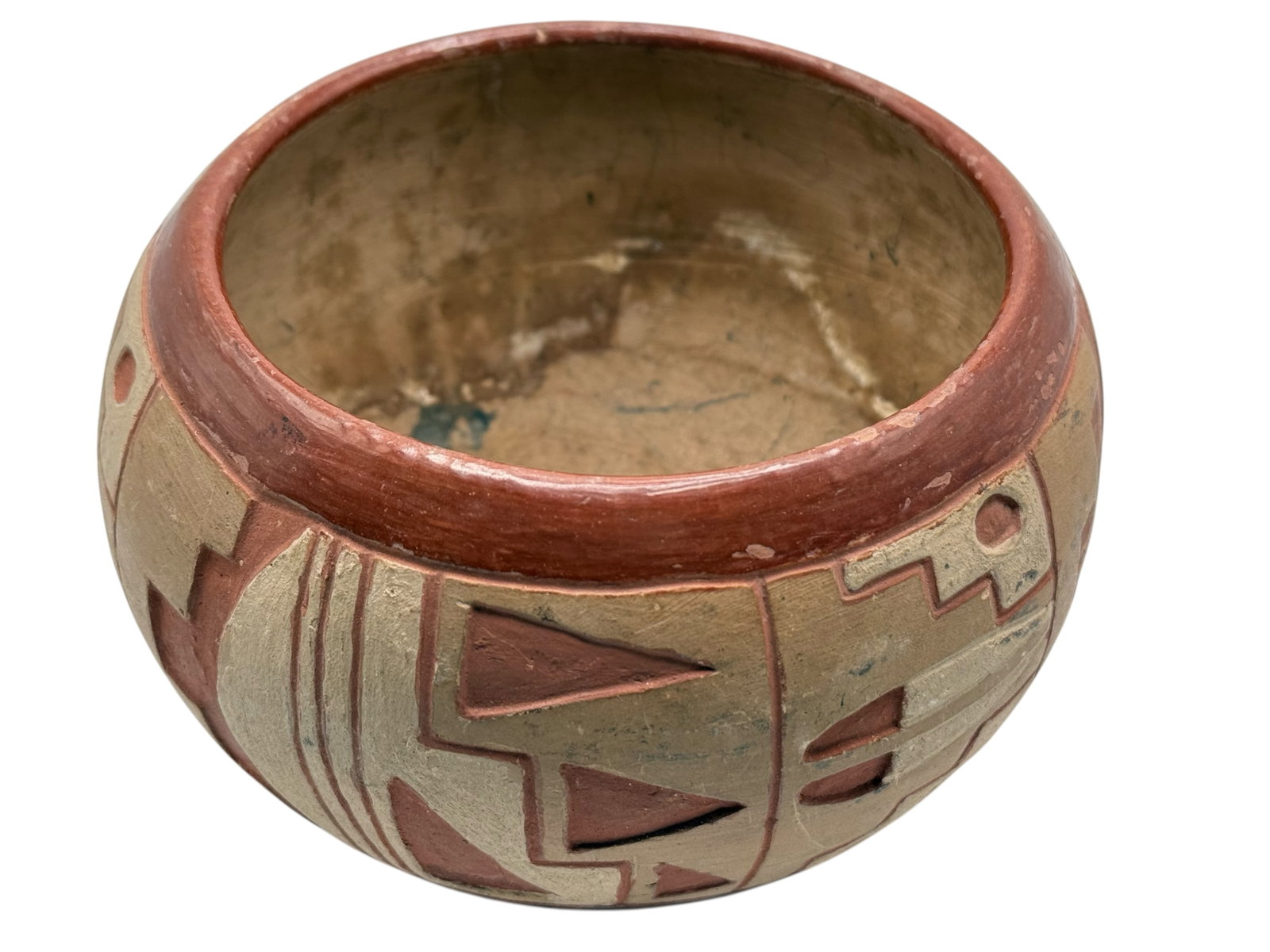 A Native American Pottery Bowl: Decorated with geometric motifs in red and buff tones. H: 4 inches W: 5 1/2 inches