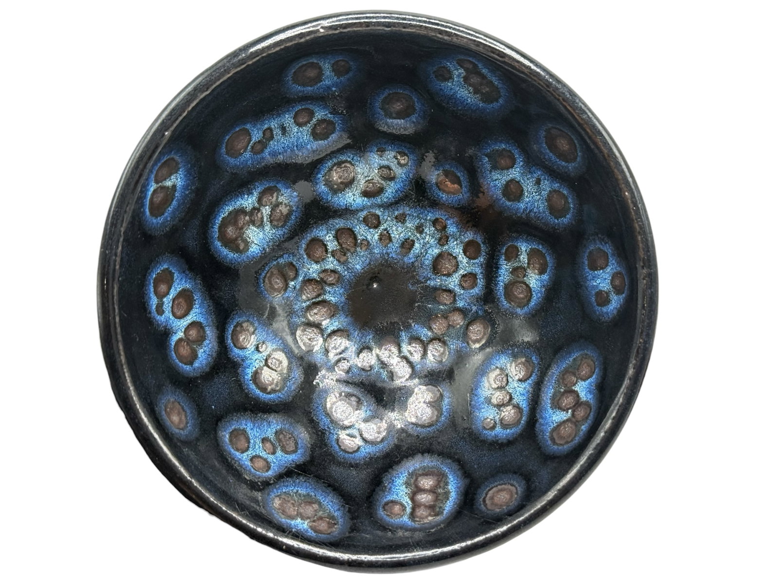 A Chinese Jian-Type Hare’s Fur Glazed Bowl: Conical form, covered to the interior with a dark glaze with blue iridescent oil-spot markings. H: 2 inches D: 4 inches