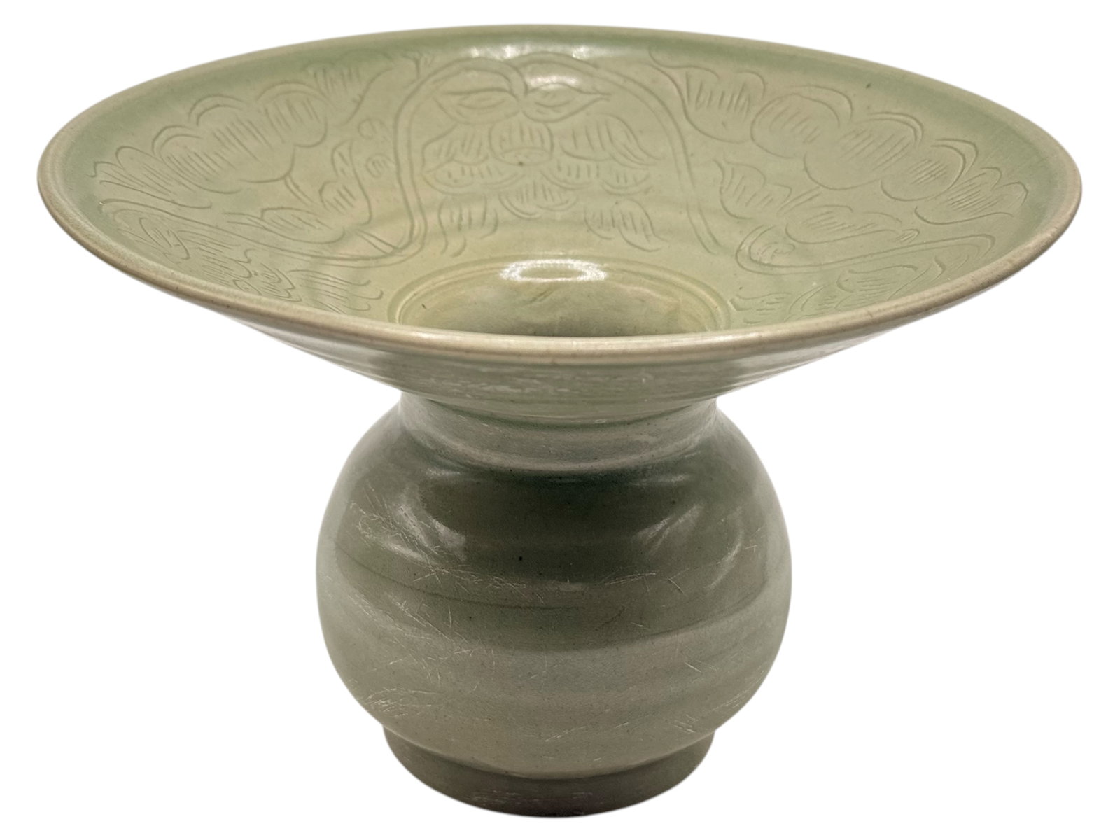 A Chinese Celadon Stem Bowl: Incised to the interior with floral decoration. H: 6 1/2 inches W: 6 1/2 inches