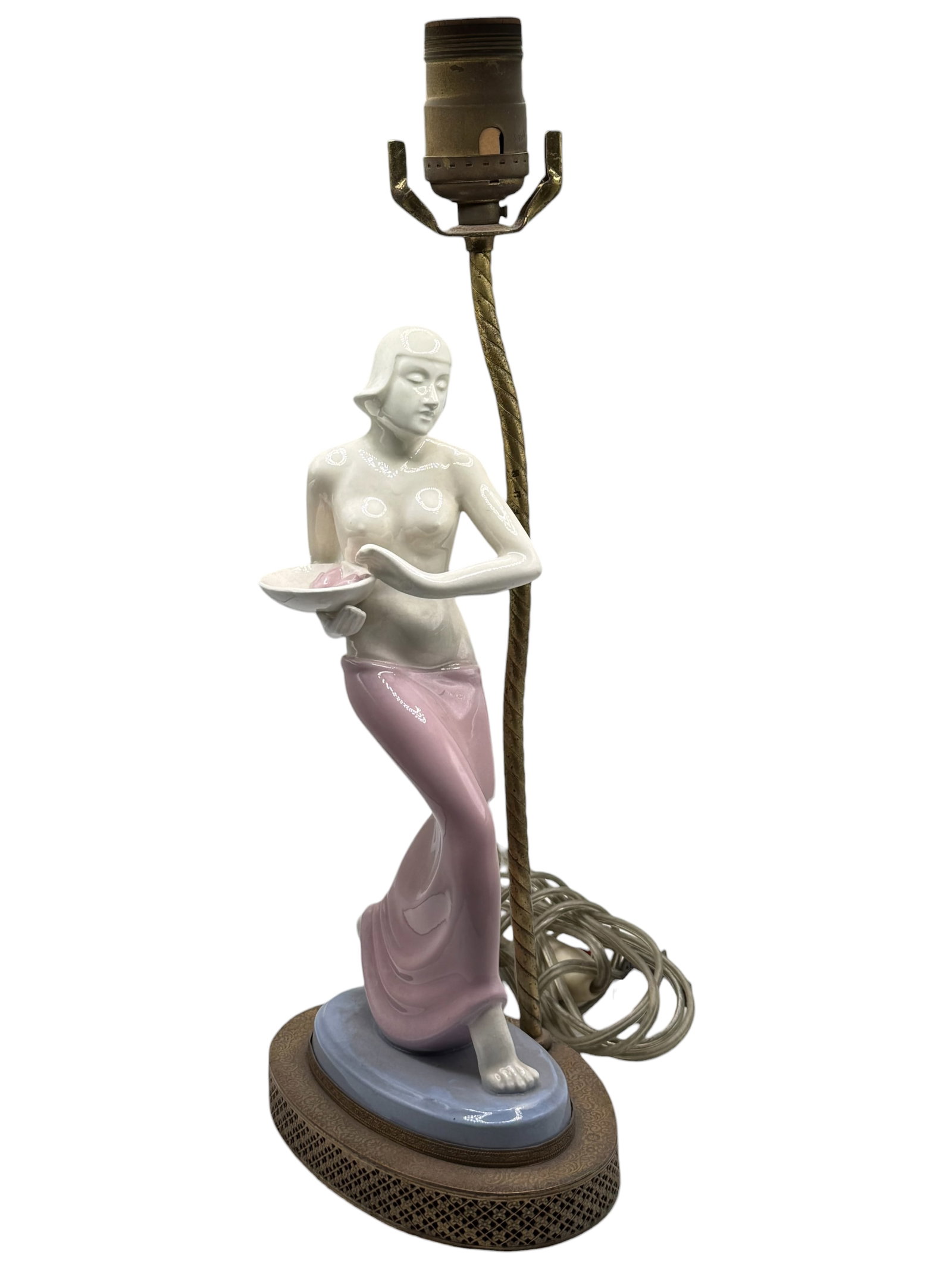 Art Deco porcelain figure lamp: Modeled as a standing female figure holding a bowl, mounted on an oval base. H: 15 inches W: 6 inches D: 4 1/2 inches