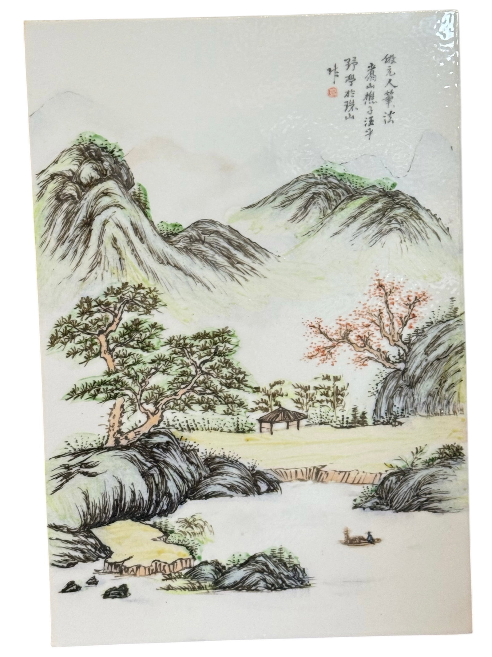 A Chinese Porcelain Landscape Plaque: Rectangular plaque painted with a mountainous river landscape, trees, pavilion, and calligraphic inscription. H: 14 1/2 inches W: 10 inches