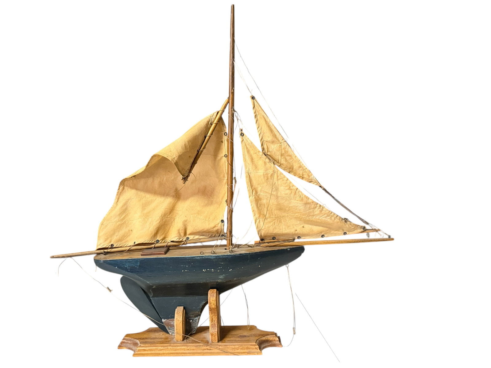 A Model Sailing Boat: Mounted on a wooden display stand. 27 1/2 inches W: 25 inches D: 5 inches
