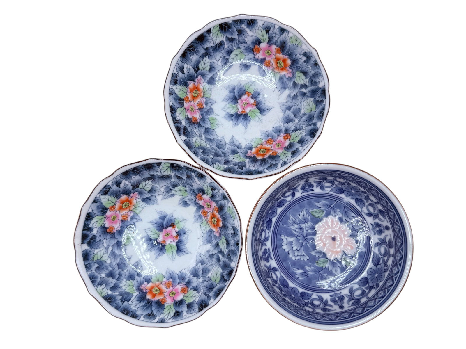 Three Japanese Blue and White Porcelain Dishes: Two decorated with polychrome floral decoration and one with underglaze blue floral decoration. H: 1 1/2 inches D: 5 1/2 inches