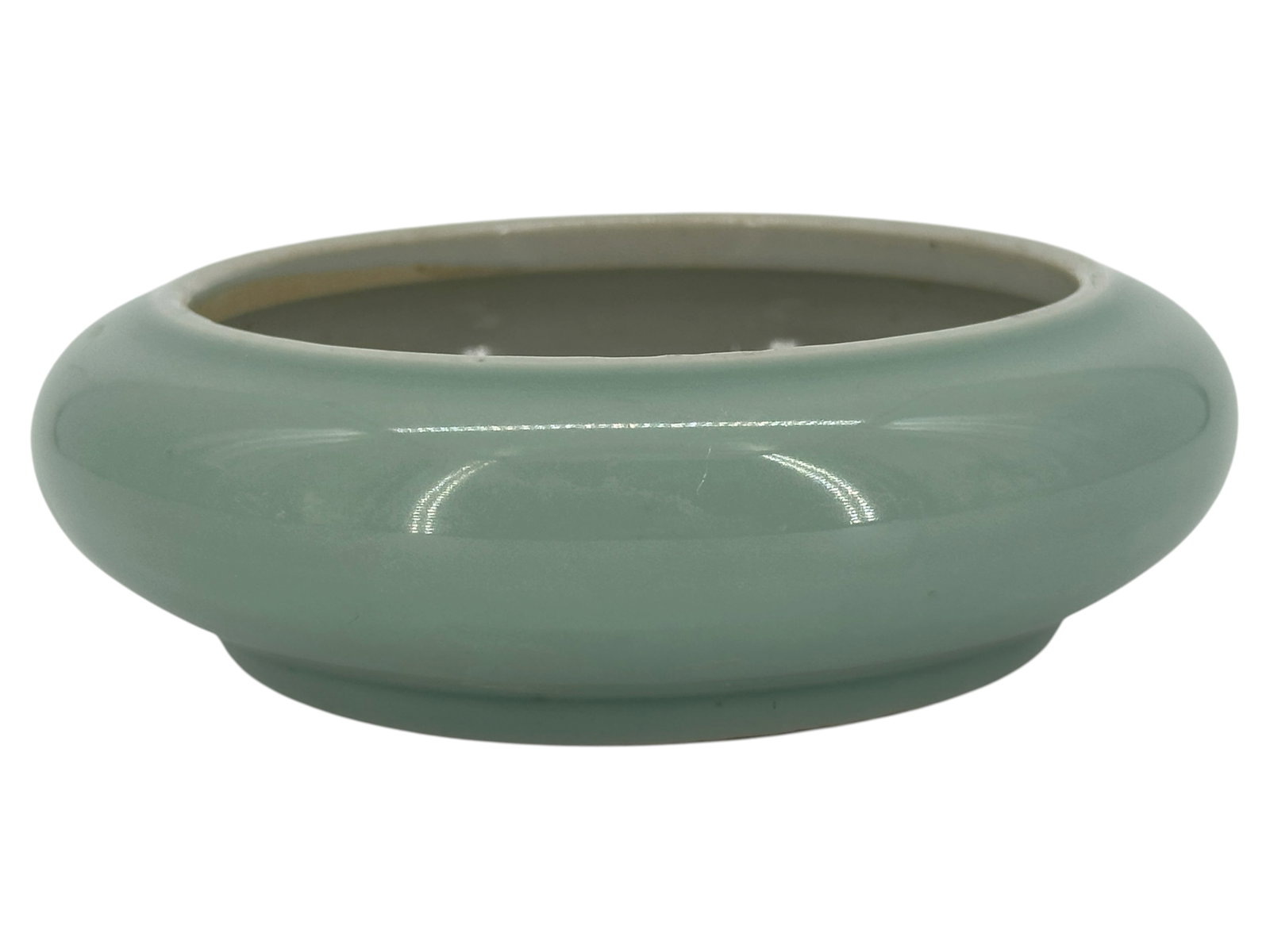 A Chinese Celadon-Glazed Brush Washer: Of compressed circular form with rounded sides, covered in a celadon glaze. Size: 1 1/2" *5 1/8"