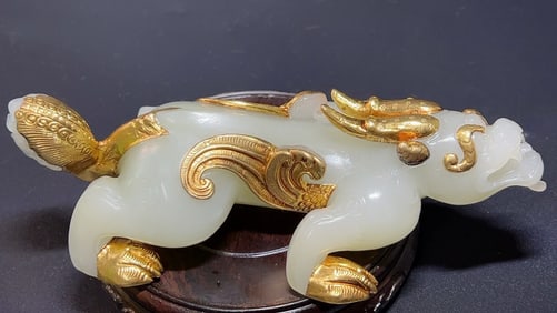 Covered with gold and inlaid with white jade and brave animals