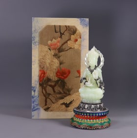 A Hetian jade Buddha inlaid with silver