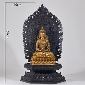 A gilt-bronze Longevity Buddha statue with a rosewood base