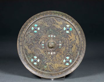 A copper-inlaid and engraved hunting scene mirror from before the Ming Dynasty