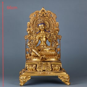 A gilt-bronze Tara with a back light