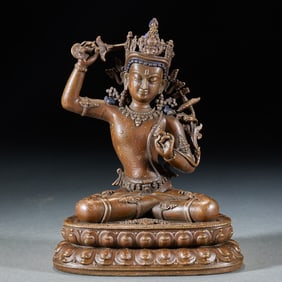 A gilt-bronze Manjusri holding a sword