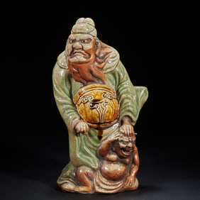 A plain tricolor glazed plaque depicting Zhong Kui catching ghosts