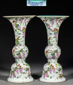 A pair of flower vases with squirrels and grapes in pink enamel, made during the Qianlong period of