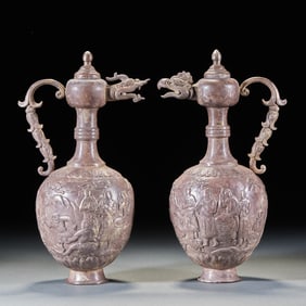 A pair of silver vessels with figures and dragon and phoenix-shaped spouts from before the Ming