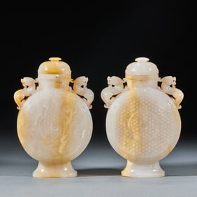 A pair of ancient jade beast-ear vases from before the Ming Dynasty