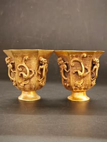 A Tang Dynasty gilded bronze octagonal chilong cup
