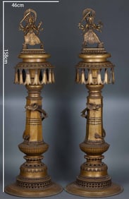 A pair of alloy copper six-armed Manjusri candlesticks