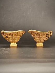 A gilded copper wine vessel with high relief engraving of a Chi dragon