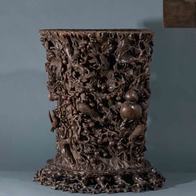 A pen holder with exquisite agarwood carvings of auspicious and prosperous flowers and birds