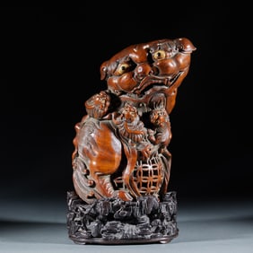 A bamboo-carved lion playing with a hydrangea