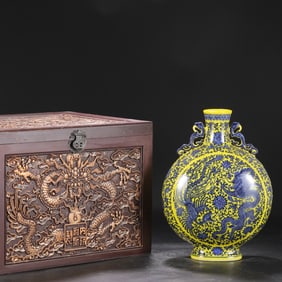 A large flat bottle with yellow ground and blue and white patterns of dragons and phoenixes from the