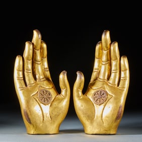 A pair of gilded copper Buddha hands