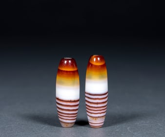 A pair of coiled celestial beads