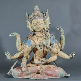 A four-headed, eight-armed copper statue of Guanyin Buddha, painted in polychrome