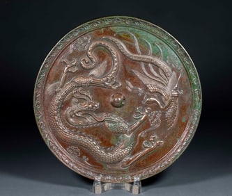 A Northern Wei Dynasty gilded and painted stone relief of flying apsaras and the Buddha's halo