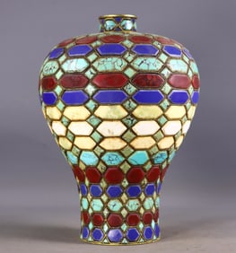 A gilded copper vase with eight auspicious symbols inlaid