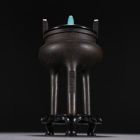 A copper censer with upturned ears and a high stand from the reign of Emperor Xuande of the Ming