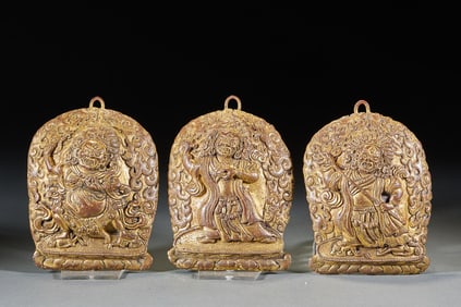 A set of gilded copper protective amulets
