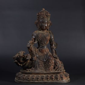 A copper figure of Manjusri Bodhisattva with partially gilded surface