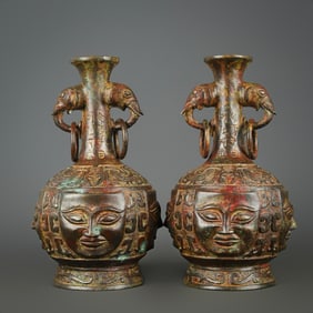 A pair of bronze vases with human faces and elephant ears from the Western Zhou Dynasty
