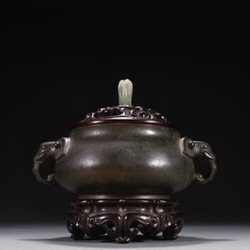An ancient-style copper incense burner with elephant trunk-shaped ears