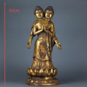 A gilt-bronze double-headed lotus Buddha statue