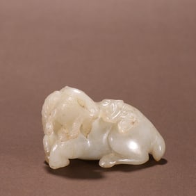 Sheep-shaped jade ornament with a ruyi in its mouth from Hotan