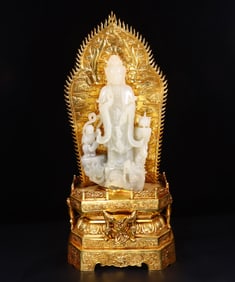 A gilded and inlaid Hetian white jade statue of "Guanyin Delivering a Child"